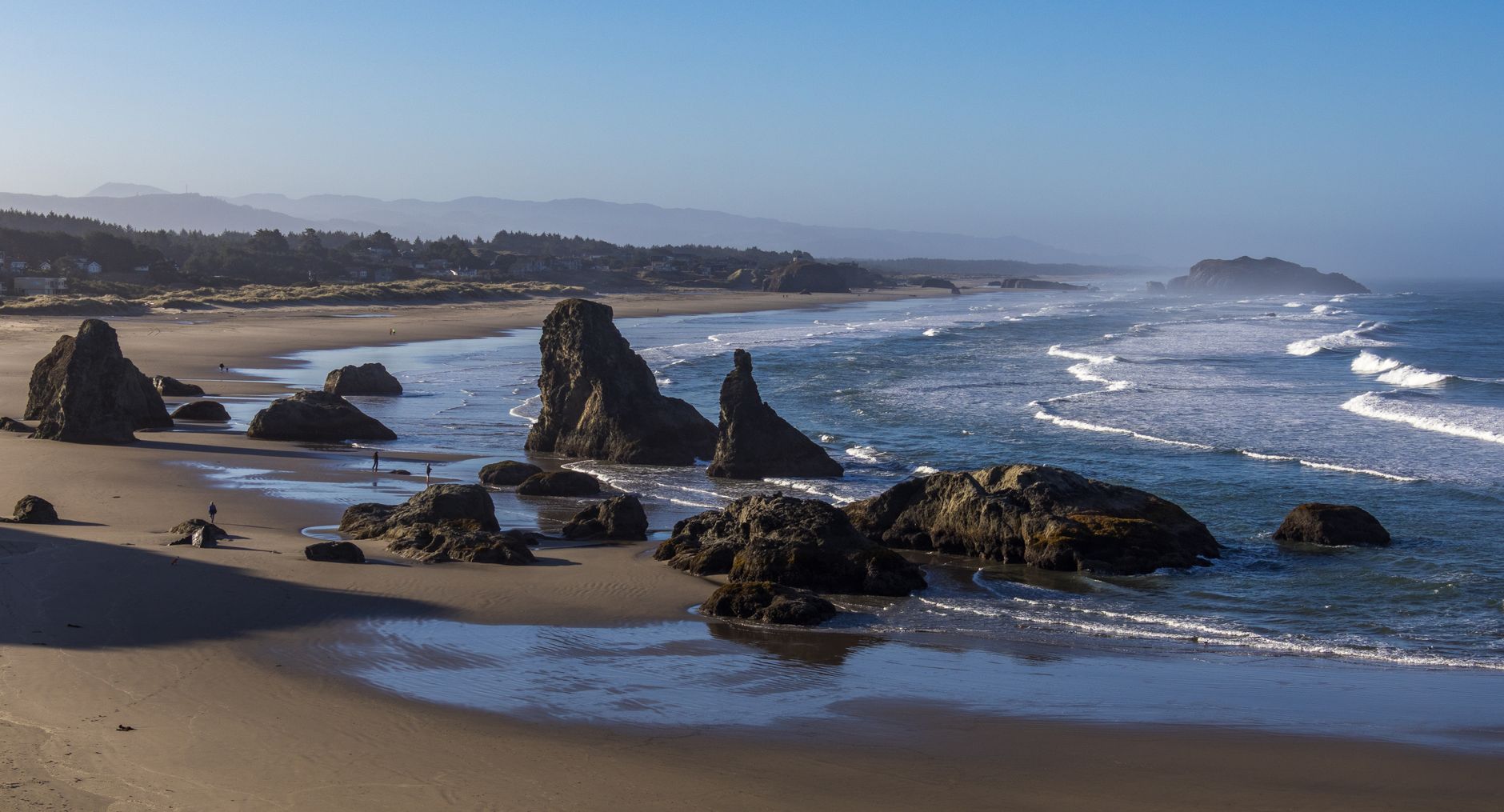 Rock formations and surf along an Oregon beach at low tide