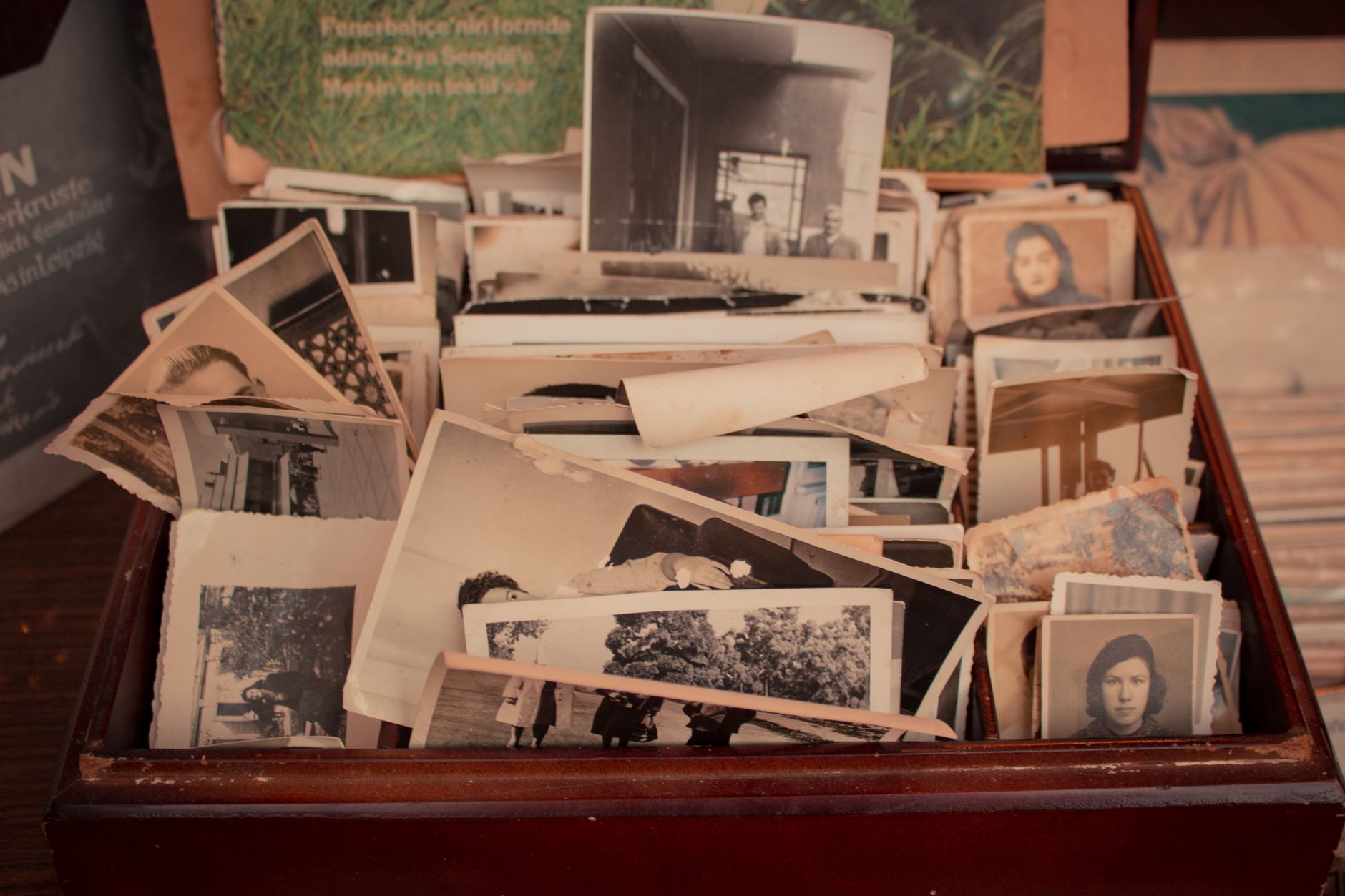 A wooden box filled with old black-and-white family photographs
